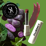 Fluency vegan makeup product called MultiStick from Fluency, Beauty showcased with a swatch of the product, purple potatoes, and spirulina, awarded a beauty award in 2024.