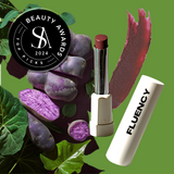 Fluency vegan makeup product called MultiStick from Fluency, Beauty showcased with a swatch of the product, purple potatoes, and spirulina, awarded a beauty award in 2024.