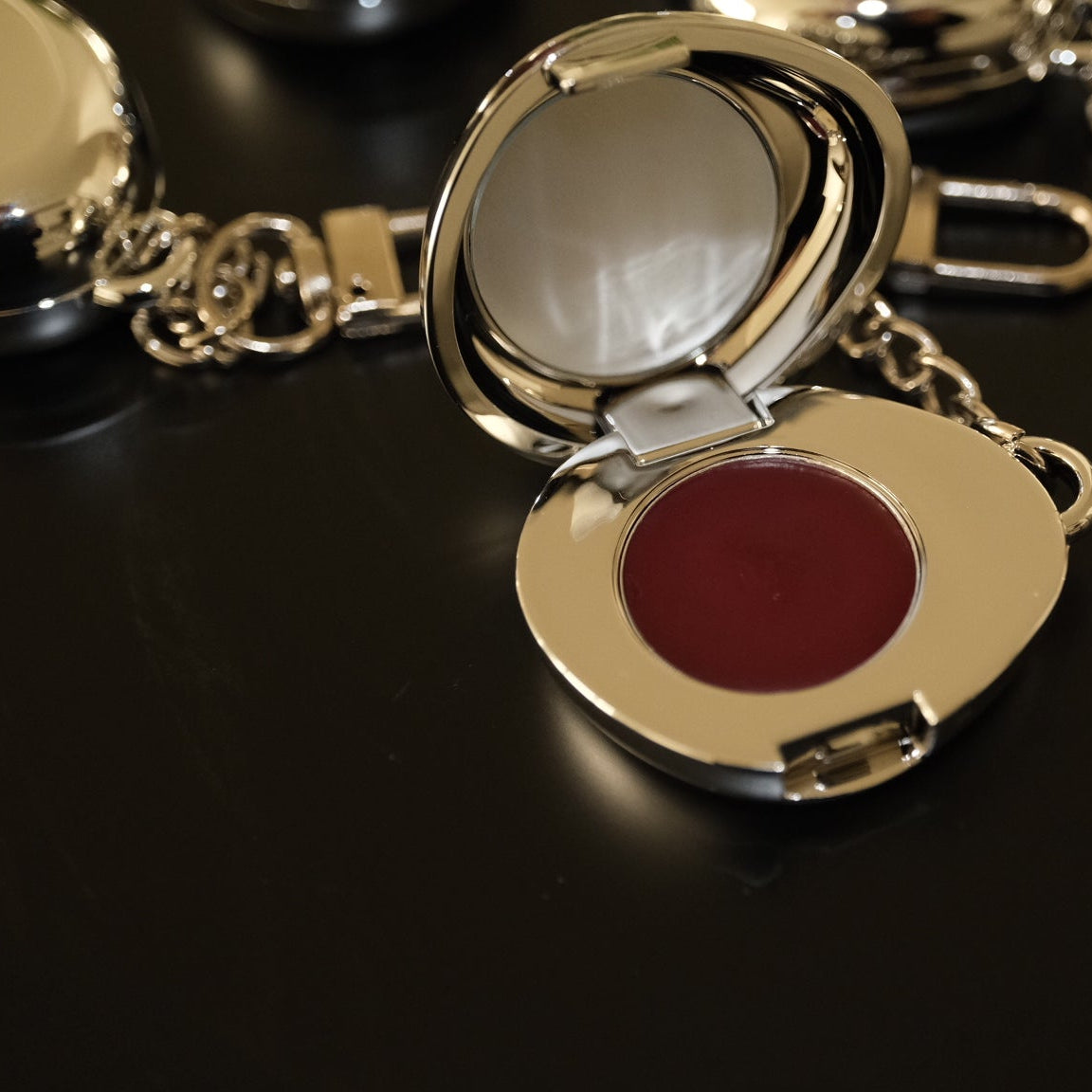 Fluency Keychain in silver chrome charm with makeup open