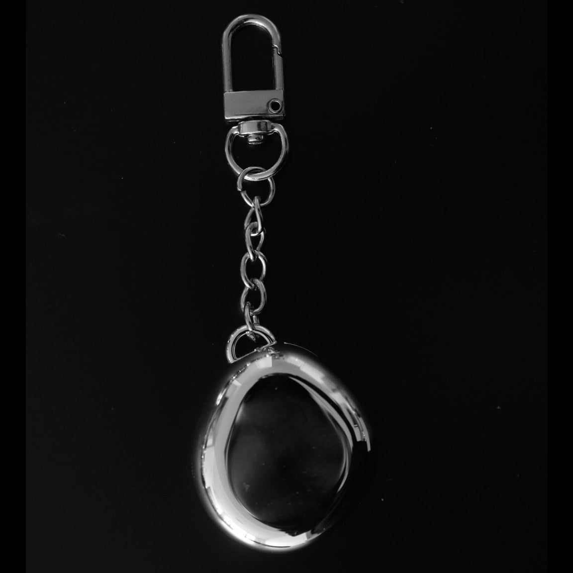 Chic chrome keychain in a modern oblong charm shape, with mirror and makeup inside for fluency beauty