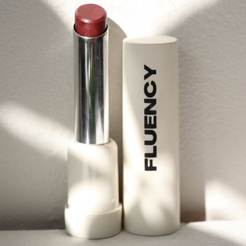vegan, plant-based Lipstick with 'FLUENCY' branding on a light background