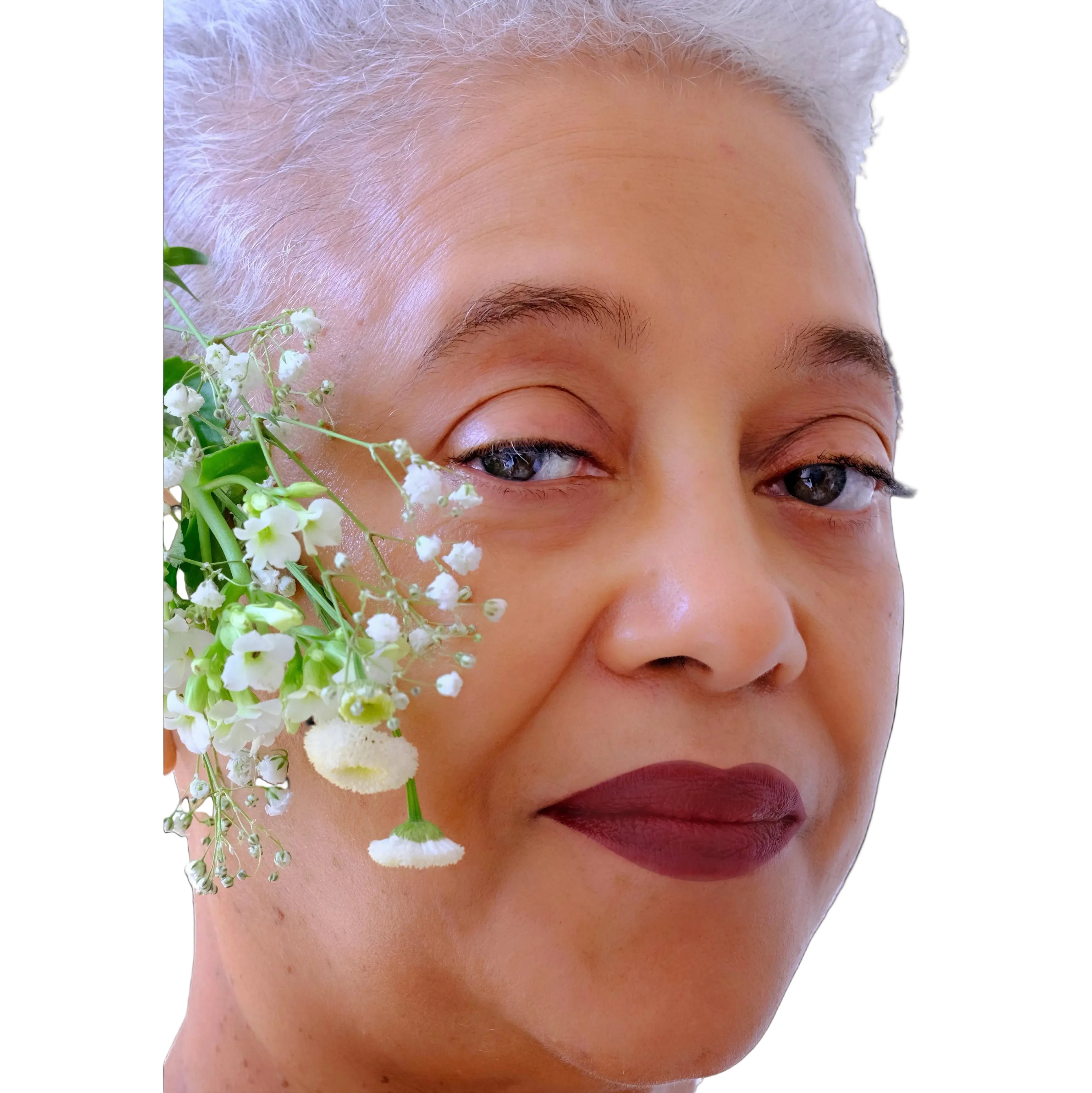mature portrait beautiful woman surrounded by white flowers wearing brown vegan lipstick makeup plant-based colored from superfoods like beets, potatoes, radish, natural makeup, natural ingredients, vegetables.
