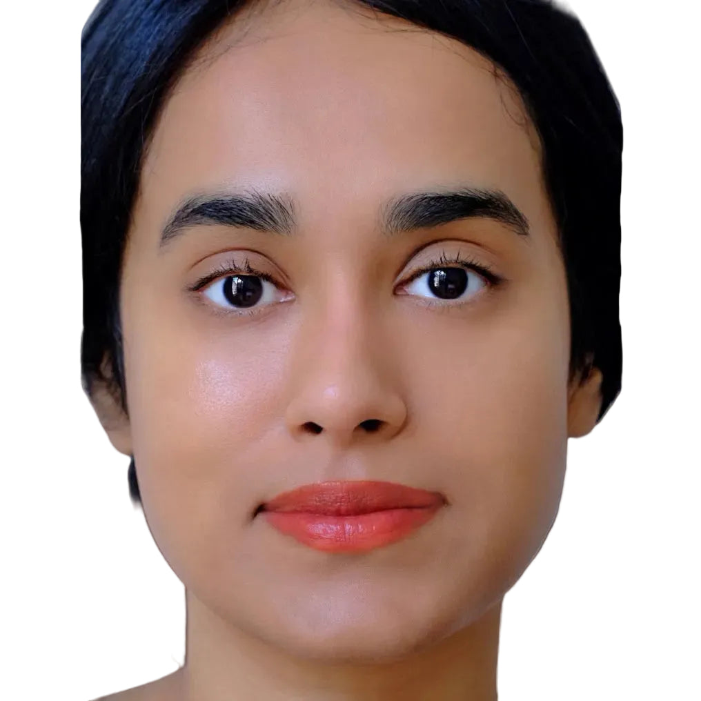 Close-up of a person with a neutral expression on a white background wearing fluency beauty vegan makeup colored from superfoods vegetables beets potatoes radish